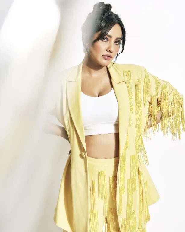 Neha Sharma in in Nirmooha's Lemon Yellow Cording Bralet with Ring and attached Hand Embroidered Tassels Fringes,Lemon Yellow Oversized Blazer with Hand embroidered Tassels Fringes and Pants from Magical Wilderness Collection