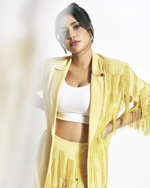 Neha Sharma in in Nirmooha's Lemon Yellow Cording Bralet with Ring and attached Hand Embroidered Tassels Fringes,Lemon Yellow Oversized Blazer with Hand embroidered Tassels Fringes and Pants from Magical Wilderness Collection