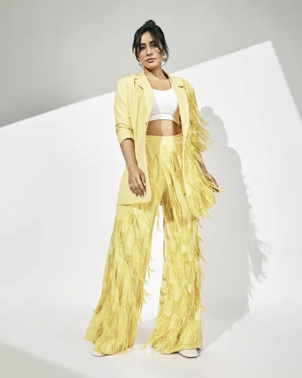 Neha Sharma in in Nirmooha's Lemon Yellow Cording Bralet with Ring and attached Hand Embroidered Tassels Fringes,Lemon Yellow Oversized Blazer with Hand embroidered Tassels Fringes and Pants from Magical Wilderness Collection