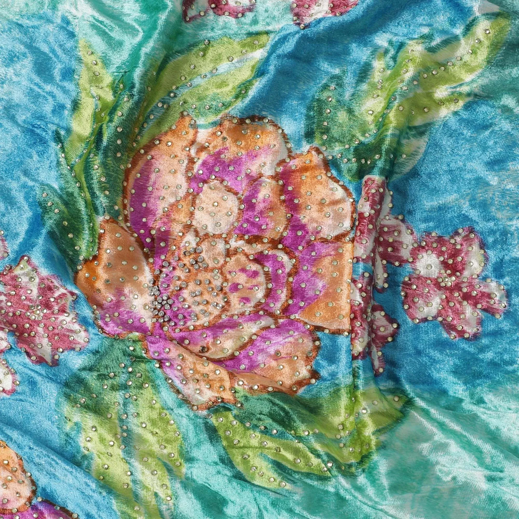 Turquoise blue to cerulean blue Rayon velvet fabric having white and yellow stonework in floral design