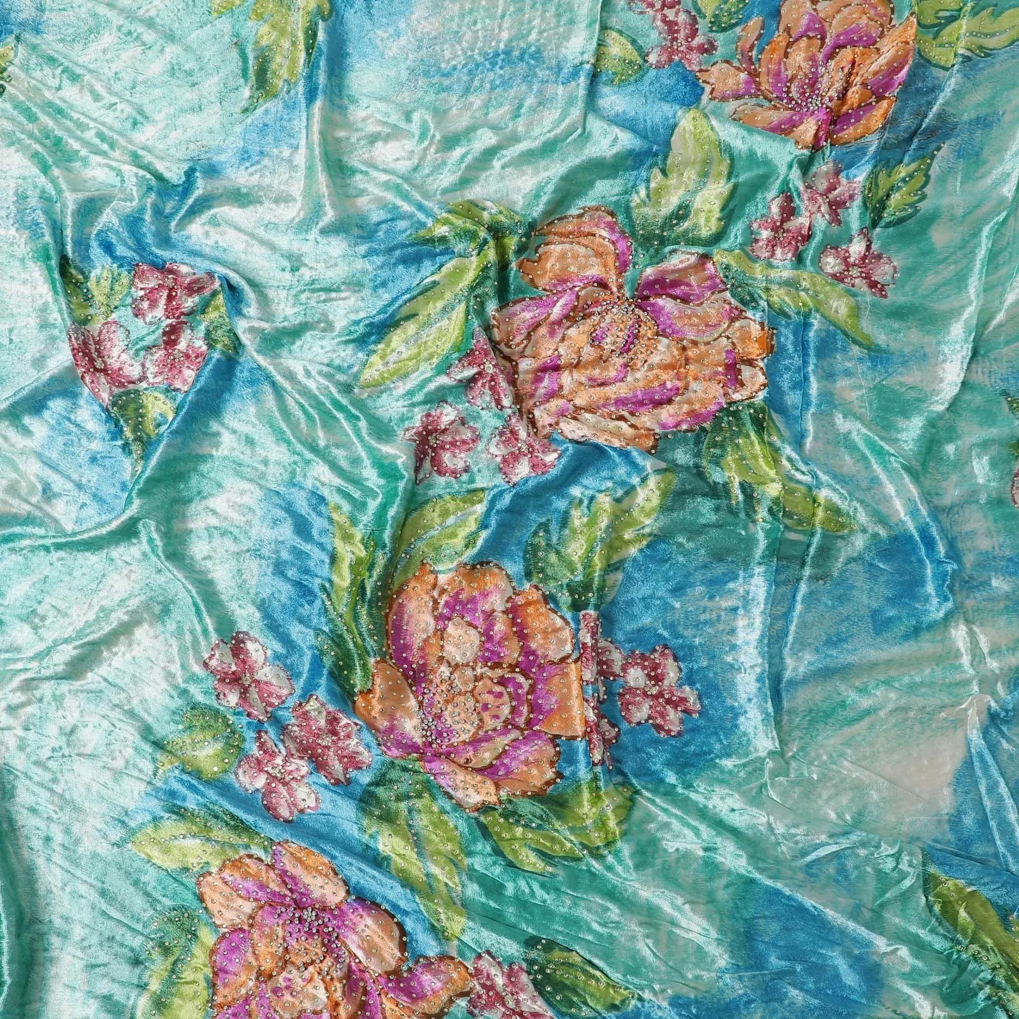 Turquoise blue to cerulean blue Rayon velvet fabric having white and yellow stonework in floral design